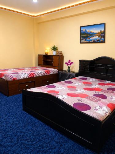 a bedroom with two beds in a room at Lama home in Bālāju