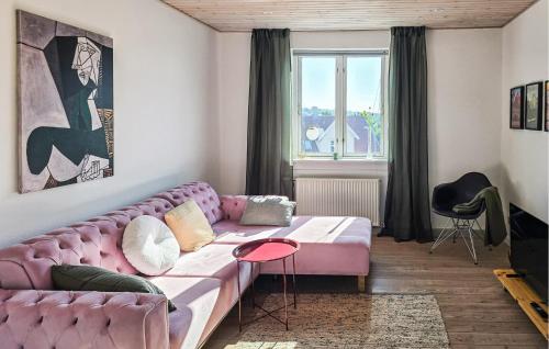 a living room with a pink couch and a window at 2 Bedroom Nice Apartment In Faaborg in Faaborg