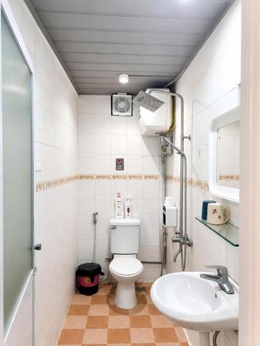 a small bathroom with a toilet and a sink at Hanowood Homestay - Renovated since June 2026 in Hanoi