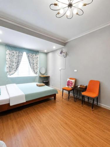 a bedroom with a bed and a table and chairs at Hanowood Homestay - Renovated since June 2026 in Hanoi