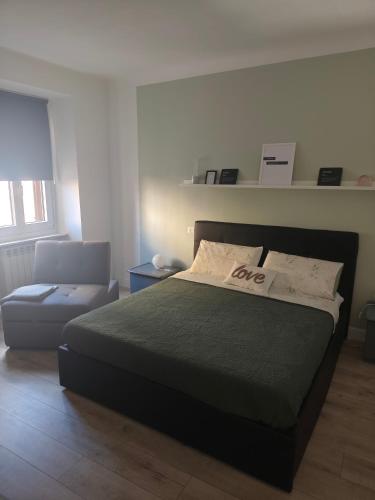 a bedroom with a bed and a couch at Your Porto Home Lake Mountain in Porto Ceresio