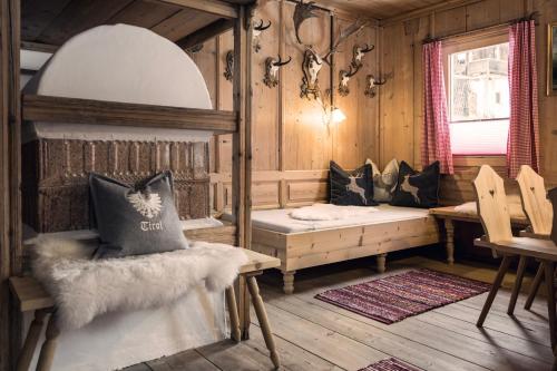a room with a bench and a table in a cabin at Joggelerhof in Finkenberg