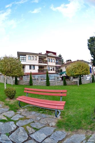 a park bench in front of a building at Jovanovic Guest House in Ohrid
