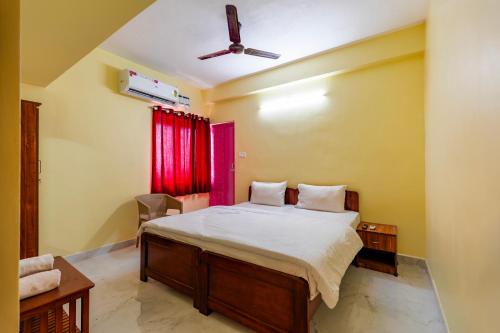 a bedroom with a bed and a ceiling fan at Subham Residency in Chennai