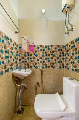 a bathroom with a toilet and a sink at Subham Residency in Chennai