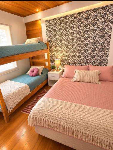 a bedroom with two bunk beds and a window at Hostal Casa Trancura in Pucón