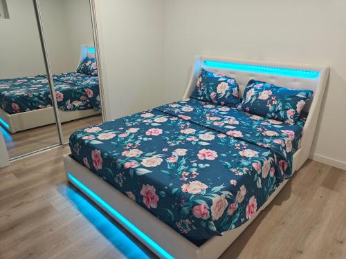 a bed in a room with a bed with flowers at New Haven- 2-Bedroom Suite in Winnipeg