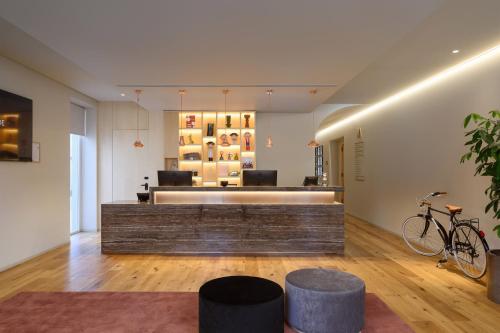 a lobby with a waiting area with a bike at INNSiDE by Meliá Braga Centro in Braga