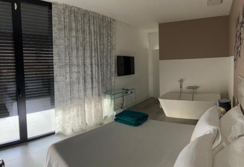 a bedroom with a bed and a tub and a window at Panoradome - Avec table d'hôtes sur réservation - Climatisé in Saint-Maurice