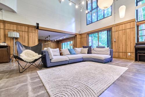 a living room with a couch and a piano at Fujisan Lodge En in Fujikawaguchiko