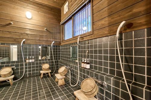 a bathroom with three toilets in a wooden building at Fujisan Lodge En in Fujikawaguchiko
