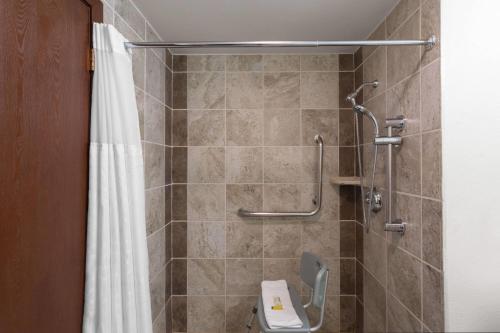 a bathroom with a shower with a toilet and a shower curtain at Super 8 by Wyndham Jackson Hole in Jackson