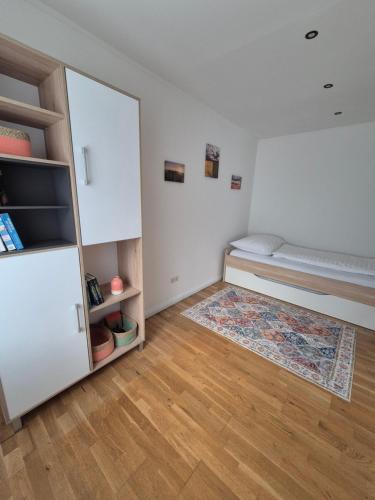 a small room with a bed and a closet at Panzers Ferienwohnungen in Asparn an der Zaya