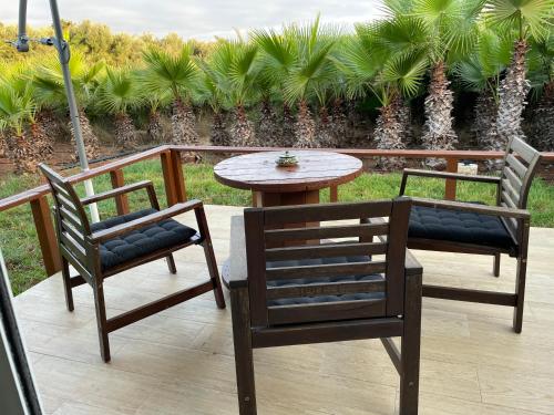 two chairs and a table on a patio at palmeraie4 in Skhirat
