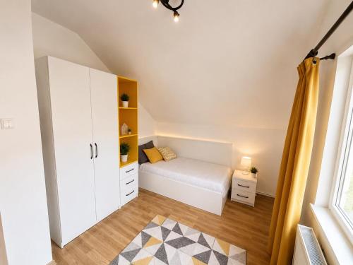 a small bedroom with a bed and a window at Vila Ioana in Ştefăneşti