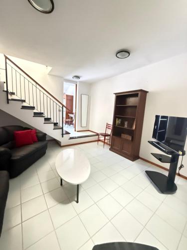 a living room with a couch and a tv at Happy Haven al mare in Riviera in Chiavari
