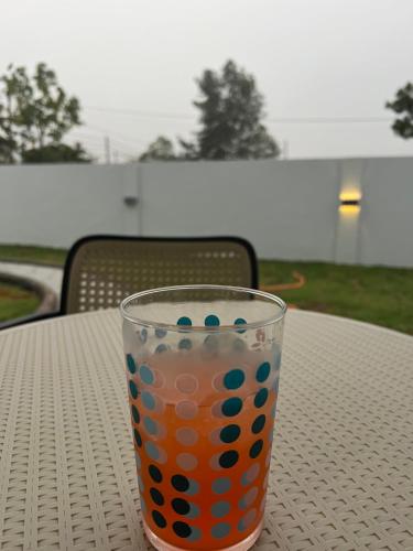 an orange and blue glass sitting on a table at Villa Hayfa in Kuala Kerai