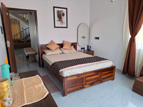 a bedroom with a bed in a room with a mirror at Journeyman Ocean Deck in Marakkānam
