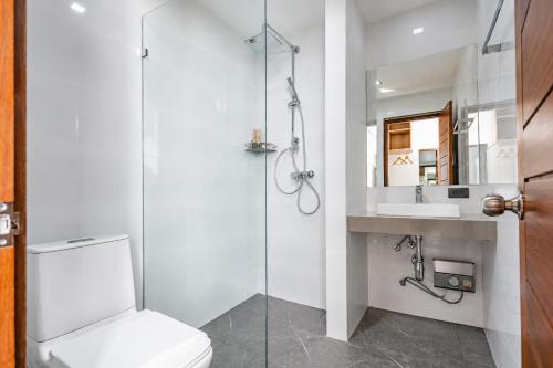 a bathroom with a shower and a toilet and a sink at M&M Hotel in Vang Vieng