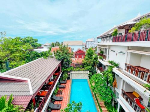 an overhead view of a swimming pool between two buildings at Indra Angkor Hotel in Siem Reap
