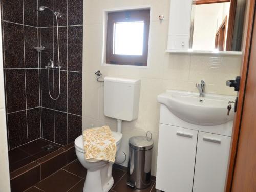 a bathroom with a toilet and a sink and a shower at Villa Marinero in Ulcinj