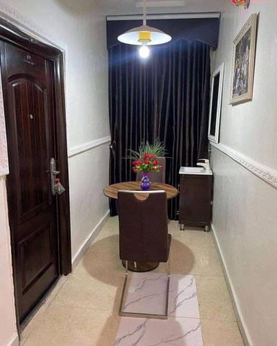 a room with a table and a window and a door at Beatrice apartment services in Warri