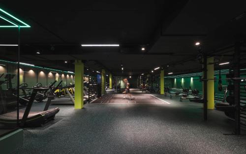 a person walking through a gym at night at Sporthotel Zoll in Vipiteno