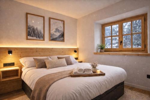 a bedroom with a large bed and a window at Luderna - Apartamento con terraza Artigues in Arties