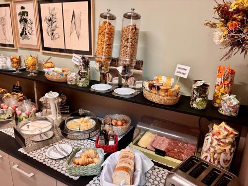 a buffet with food and baskets of bread and pastries at Residence Cavazza in Bologna