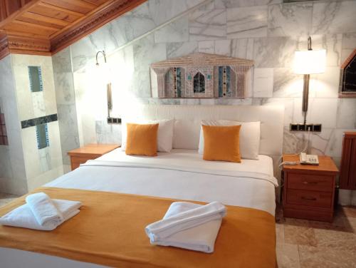 a bedroom with a large bed with two towels on it at Bc Spa Hotel in Dalyan