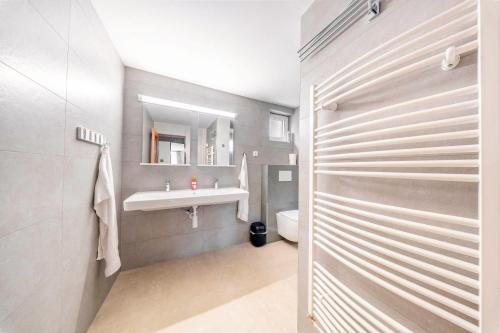 a bathroom with a sink and a toilet and a mirror at Pension Kubát in Špindlerův Mlýn