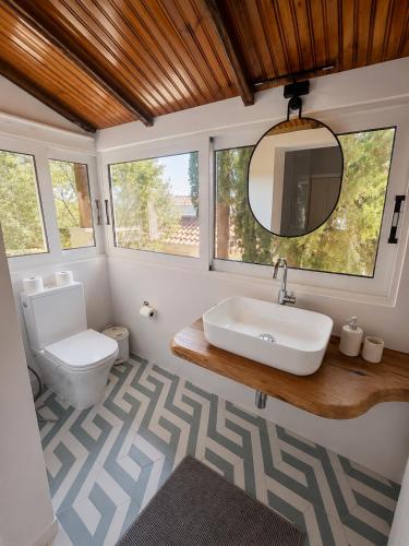 a bathroom with a sink and a toilet at Villa Keren in Oropos