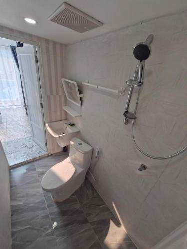 a bathroom with a toilet and a shower at River View Villas in Vang Vieng