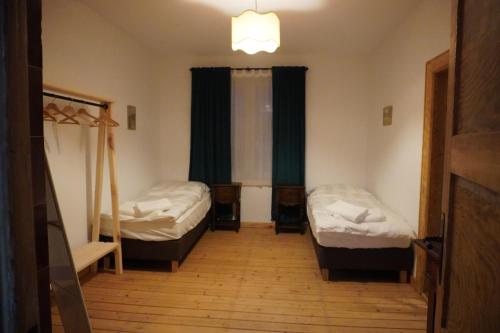 a room with two beds and a window at Odpocznij w Gołdapi in Gołdap