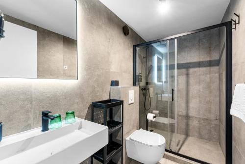 a bathroom with a sink and a toilet and a shower at Konoba Most Rooms in Buzet