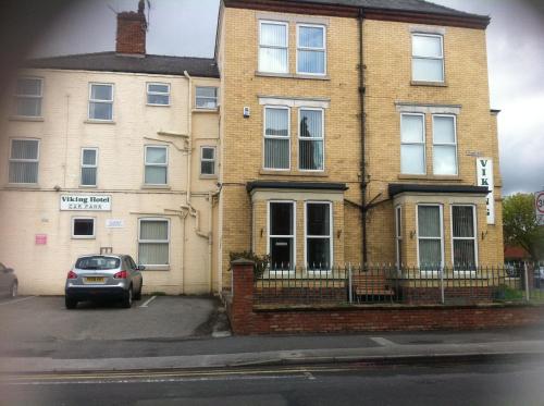 a house with a car parked in front of it at Viking Hotel in Bridlington