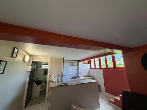 a kitchen with a sink and a counter in a room at Appartement vu sur mer in Mamoudzou