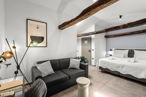a living room with a couch and a bed at Konoba Most Rooms in Buzet