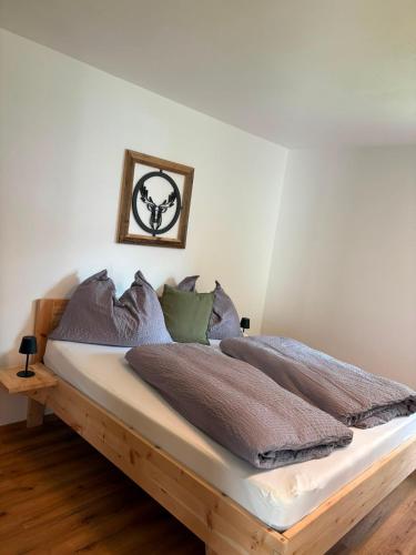 a bedroom with a bed with a wooden frame at FEWO-TomKO in Fügenberg
