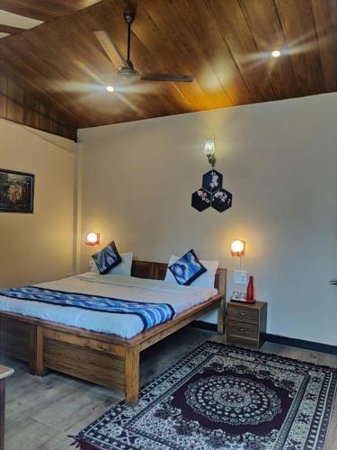 a bedroom with a bed and a ceiling fan at लेक एंड वुड्स in Bhīm Tāl