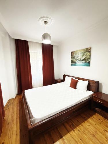 a bedroom with a large bed with white sheets at KAŞ MERKEZ İMREN APART 2 in Kaş