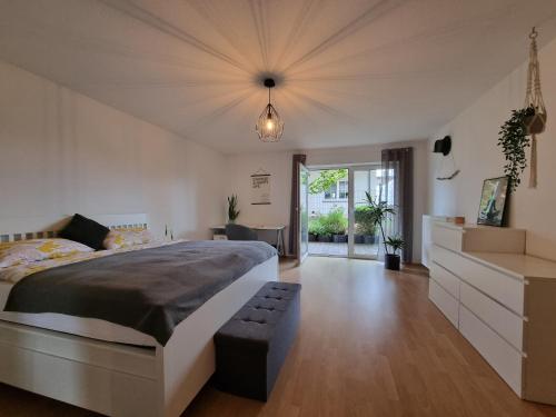 a bedroom with a large bed with a bench in it at Modernes Apartment mit Terasse in Lügde