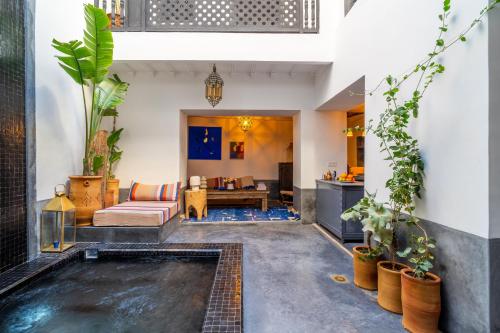 a living room with a pool in the middle of a house at Marrakech Medina - Private Riad 4 rooms Rooftop and pools in Marrakesh