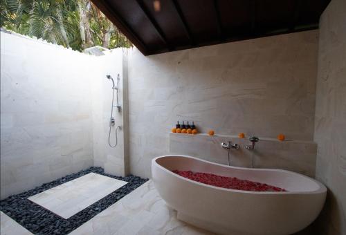 a bath tub in a bathroom with a shower at Villa Seaview- tranquil 3BR, beachfront, private pool in Bukti