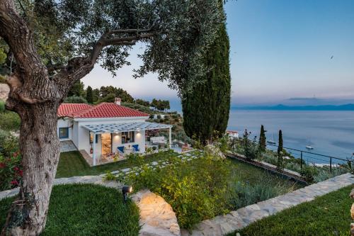 a house with a view of the water at Villa Aless in Skopelos Town