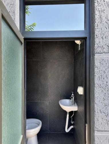 a bathroom with a sink and a toilet at La Terrazza in Tirana