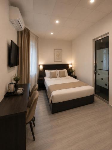 a hotel room with a bed and a desk at White Hotel in Yerevan