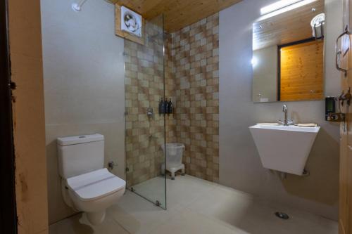 a bathroom with a toilet and a sink at The Arks Baagh Villas in Rāmnagar