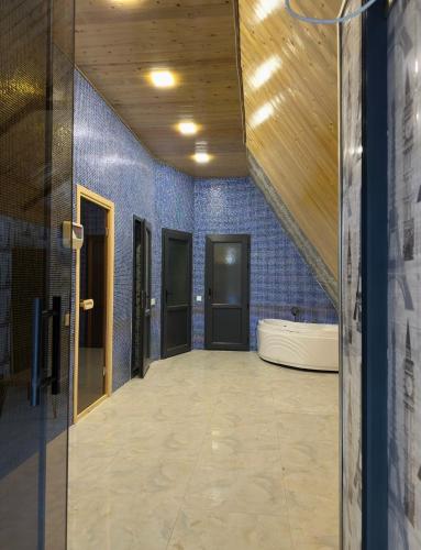 a hallway with blue walls and a bath tub at A-Frame Pool & Spa in Baku