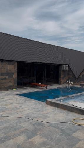 a building with a swimming pool in front of it at A-Frame Pool & Spa in Baku